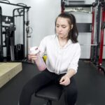 An image of a person shaking Sports Research Hydrate electrolytes in a shaker