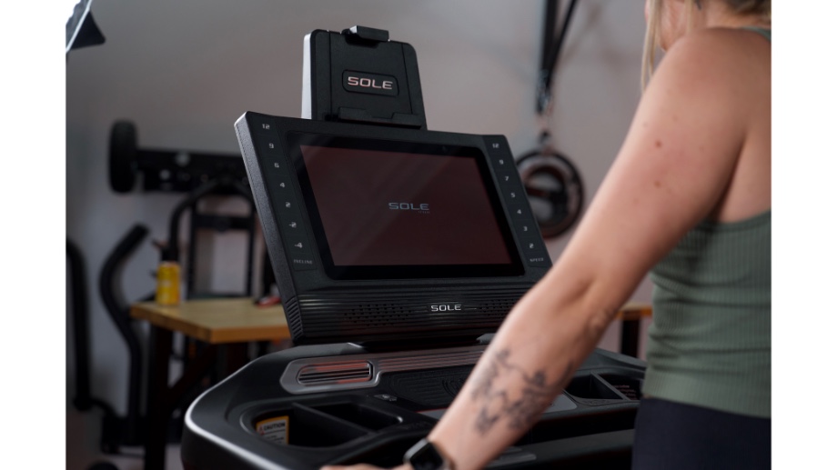 close up of woman looking at the display screen of the sole fitness tt8 treadmill