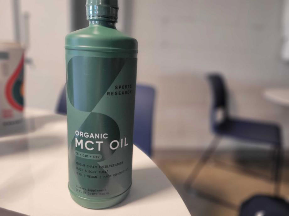 A bottle of Sports Research MCT Oil on a table