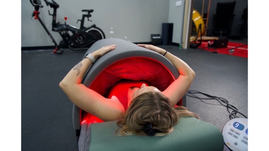 Woman inside Sunlighten Solo Sauna with arms out