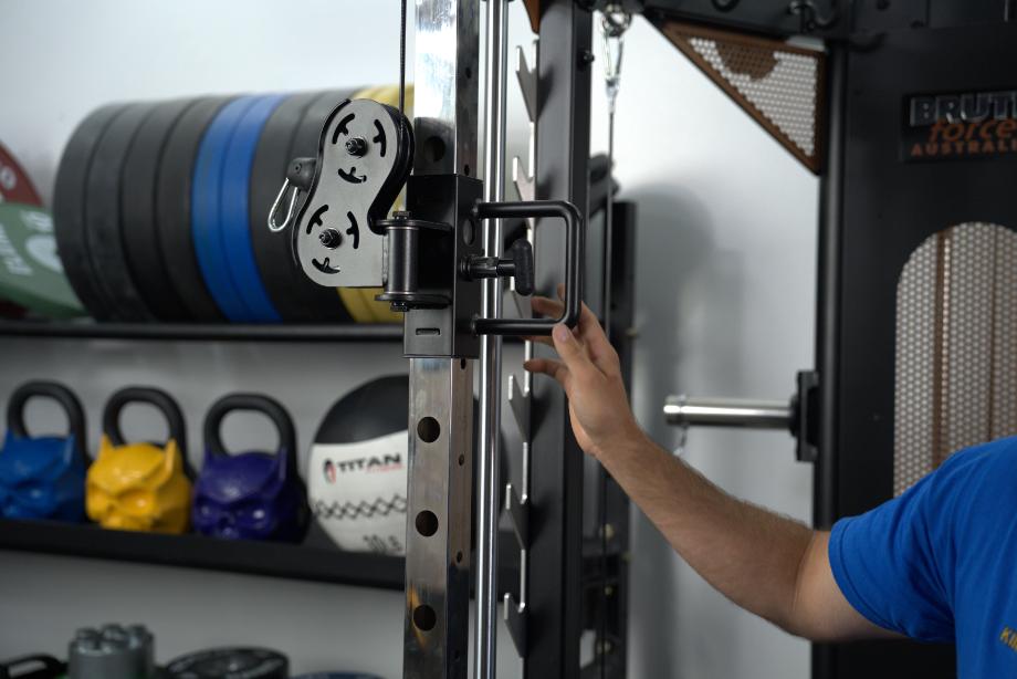 Man adjusting the trolley on the upright of the BRUTEforce UX1 Functional Trainer