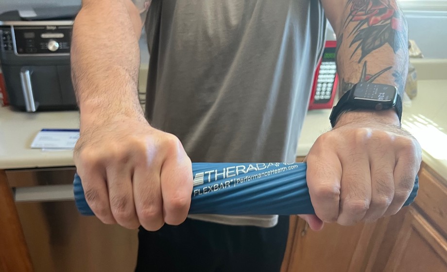 A person twisting a Theraband FlexBar