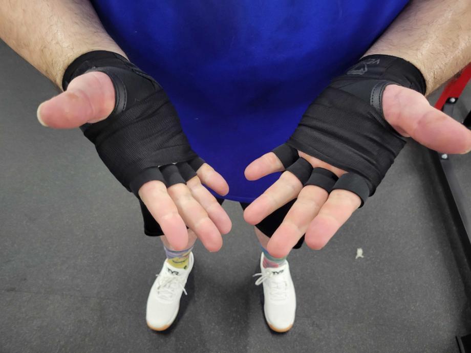 A person wearing Venum Gel Pro Wraps with their palms up.