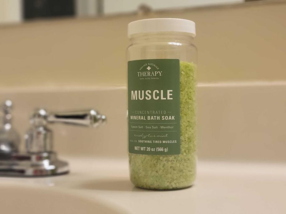 Village Naturals mineral bath soak on counter next to sink