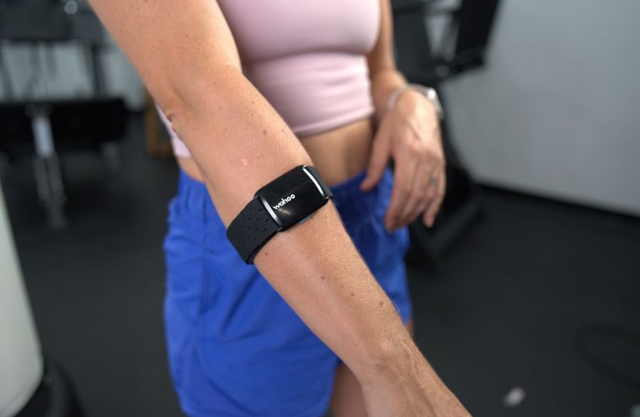 Woman wearing Wahoo ticker fit heart rate monitor around her forearm