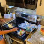 Woman Cooking Hungryroot Chicken Burrito Bowl