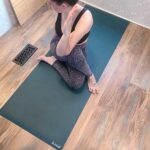 Woman doing yoga on a b, halfmoon b, mat yoga mat