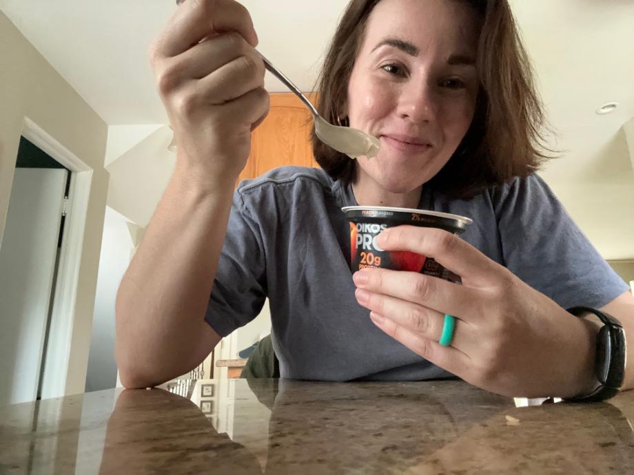 Woman eating Oikos Pro yogurt