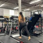 Woman running barefoot on a treadmill