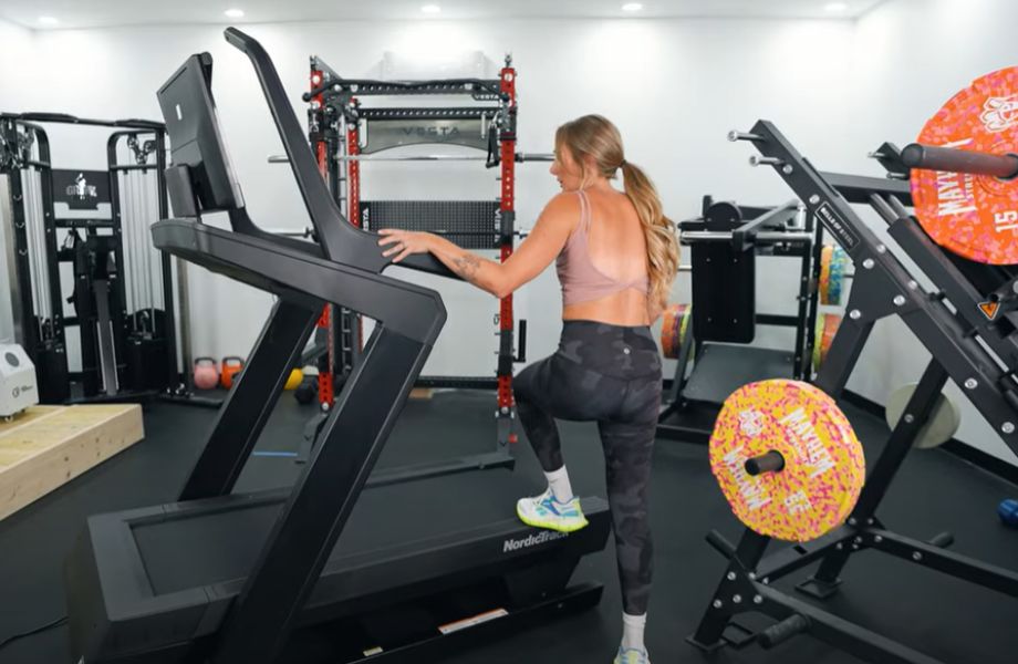 Woman stepping onto the NordicTrack X24 treadmill