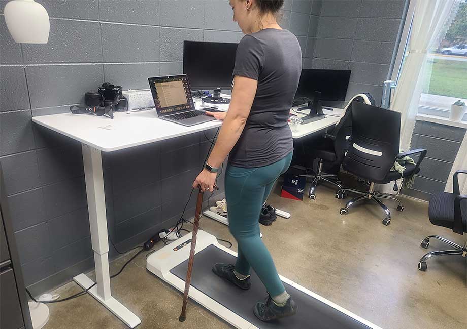 An image of a person walking on the WalkingPad C2 under desk treadmill