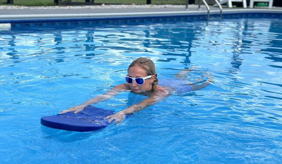 Lindsay Scheele, CPT works out using a Speedo Kickboard