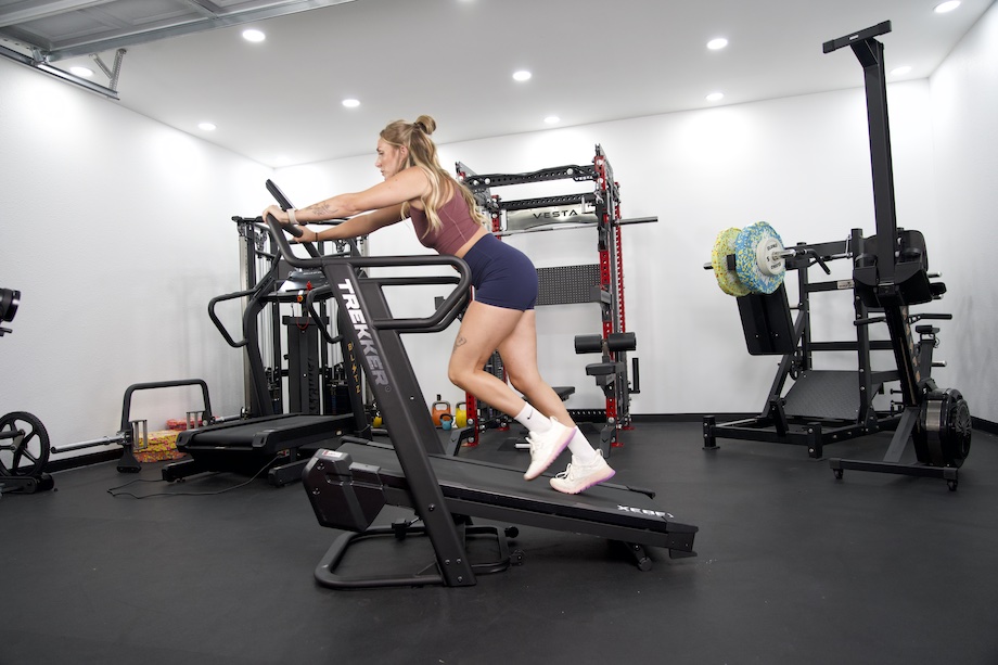 Lindsay Scheele, CPT does a sled push on the Xebex Trekker 4000 treadmill.